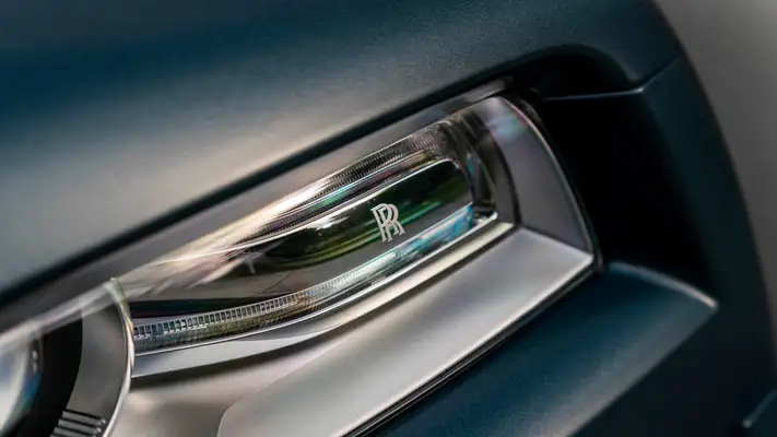 Matte blue Rolls Royce Wraith rental headlight detail view mph club