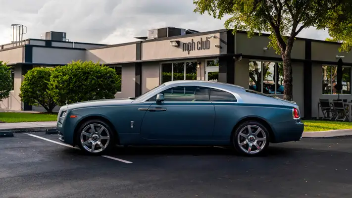 Matte blue Rolls Royce Wraith rental side view mph club