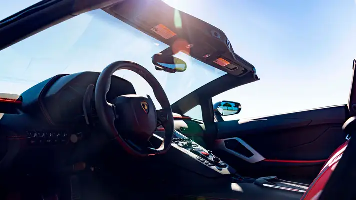 White Lamborghini Aventador S Roadster for rent Monaco dashboard view mph club