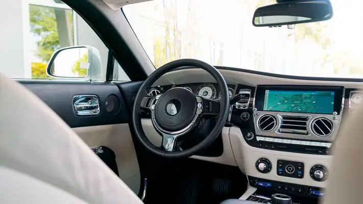 White with white interior Rolls Royce Wraith rental dashboard view mph club