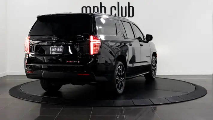Black on black Chevrolet Suburban rental rear view mph club