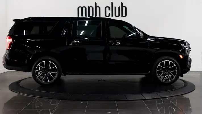 Black on black Chevrolet Suburban rental side view mph club