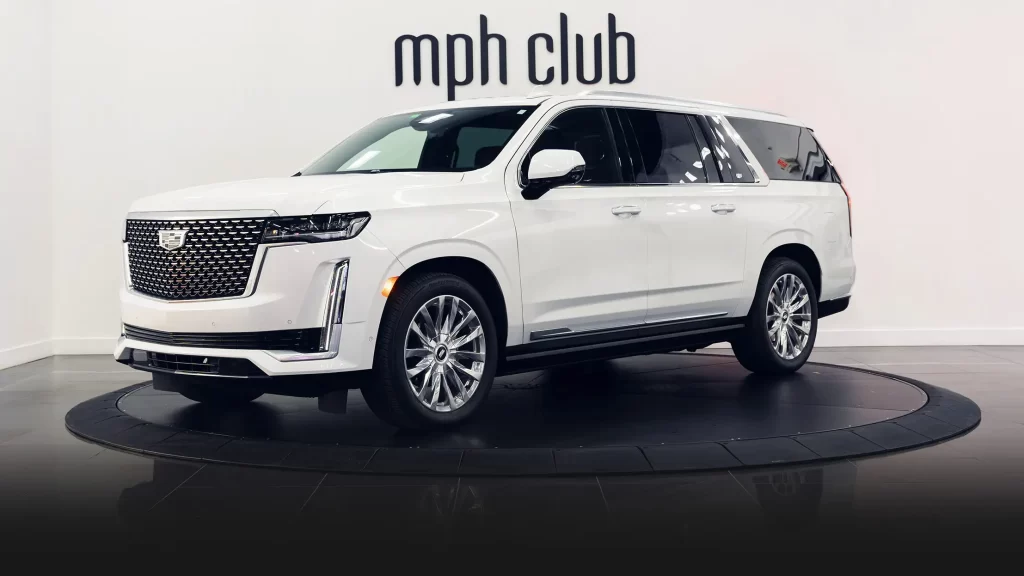 White on black Cadillac Escalade rental profile view turntable mph club