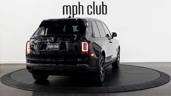 Black on orange Rolls Royce Cullinan black badge rental rear view mph club