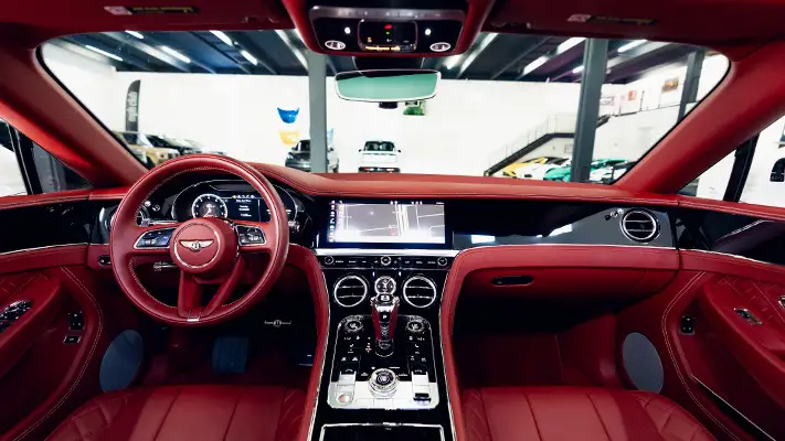 White with red Bentley Continental GTC rental dashboard view mph club