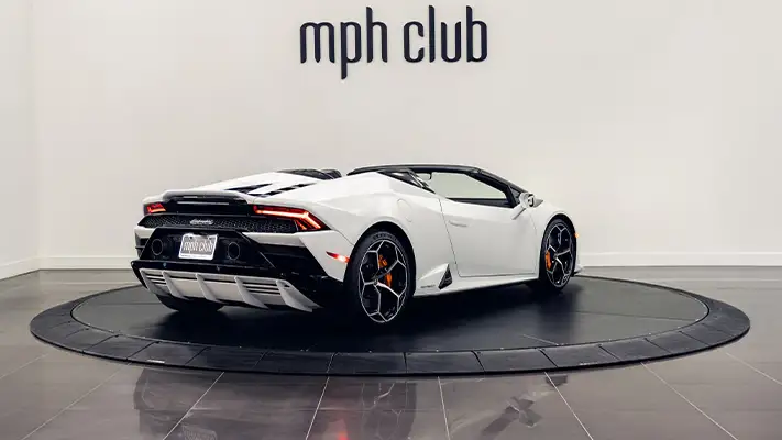 White matte Lamborghini Huracan EVO Spyder rental rear view turntable mph club