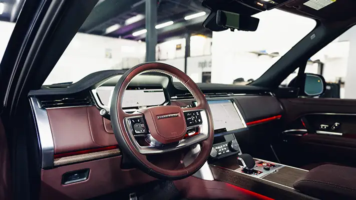 Blue Range Rover rental Monaco dashboard view mph club