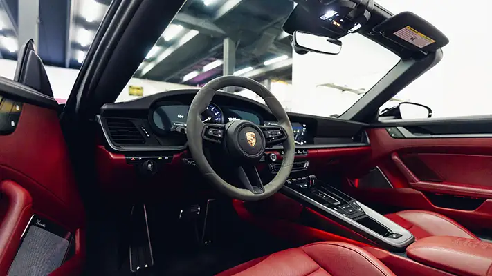 Black Porsche 911 Carrera Cabriolet rental dashboard view - mph club