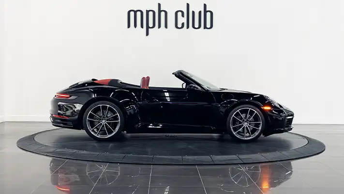 Black Porsche 911 Carrera Cabriolet rental side view - mph club