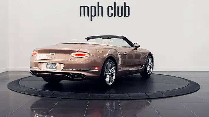 Gold Bentley Continental GTC rental rear view - mph club