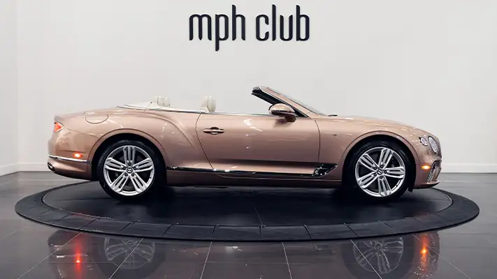 Gold Bentley Continental GTC rental side view - mph club