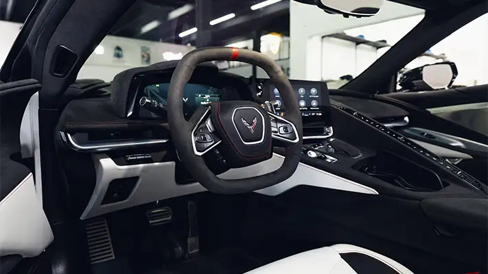 White on white Chevrolet Corvette C8 rental dashboard view - mph club