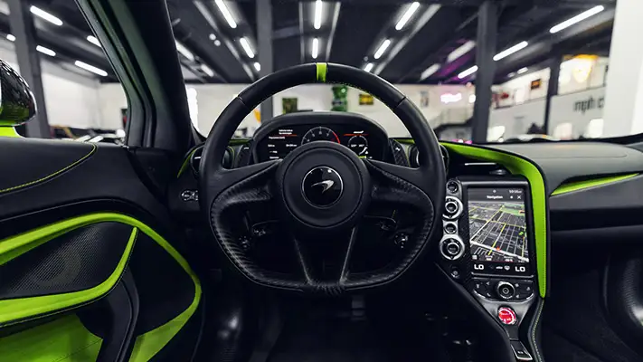 Green McLaren 765LT Spider rental dashboard view - mph club