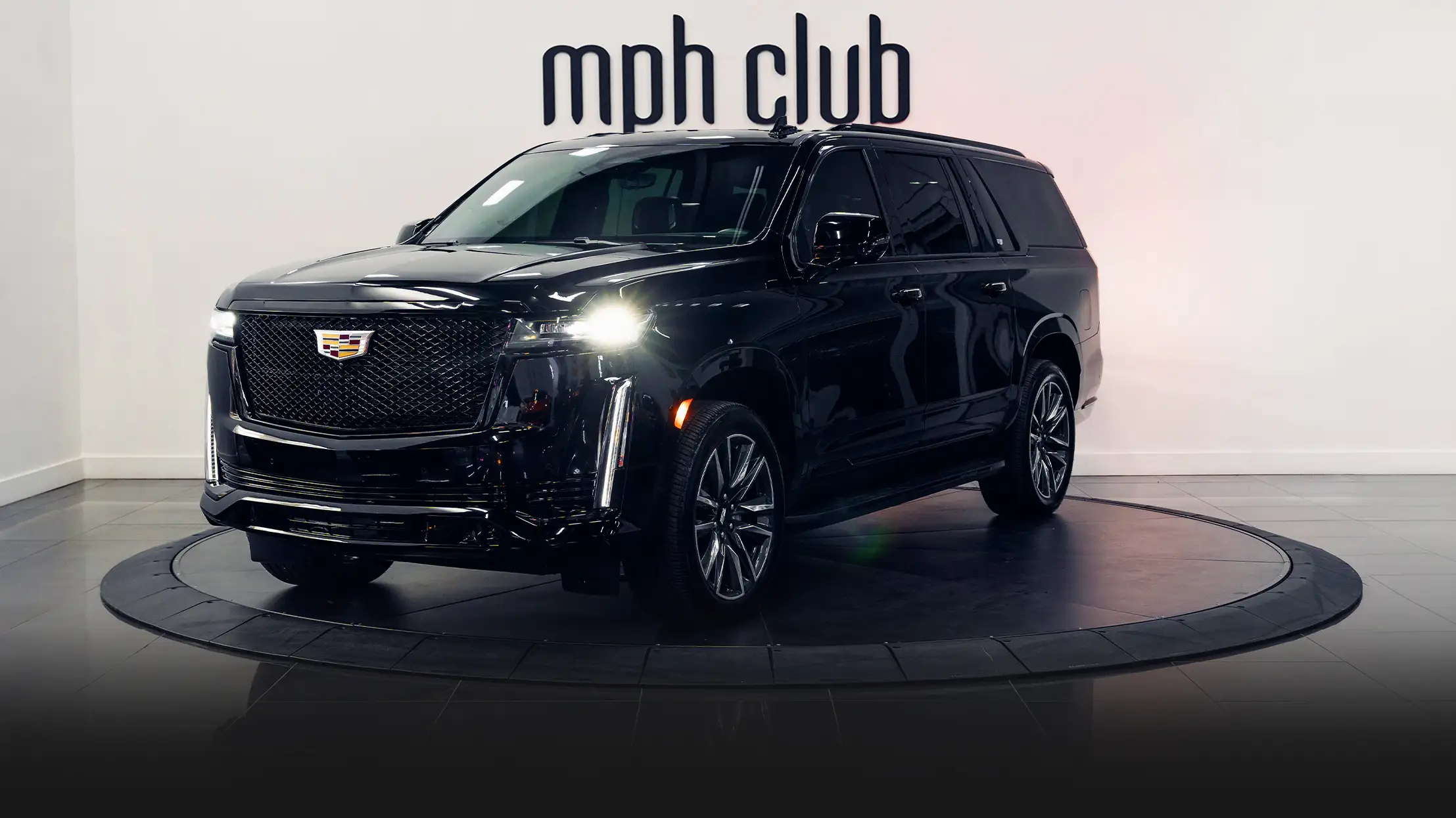 Black on black Cadillac Escalade rental profile view turntable - mph club