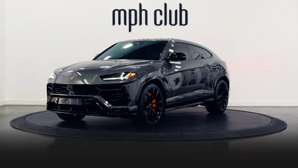 Grey on orange Lamborghini Urus for rent Monaco profile view - mph club