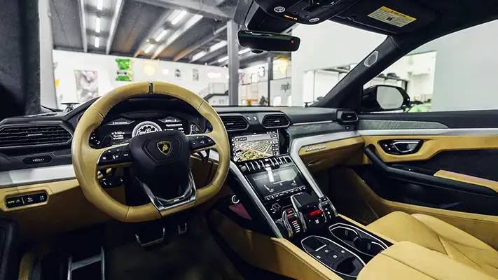 Green on brown Lamborghini Urus rental dashboard view - mph club